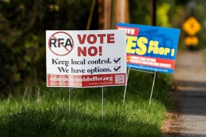 Signs in support of and opposition of the Proposition 1 annexation into RFA are visible along 100th Avenue West on Thursday, April 3, 2025 in Edmonds, Washington. (Olivia Vanni / The Herald)