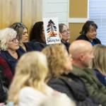 A person holds a sign referencing the recent demolition of a 100-year-old California coast redwood during a city council meeting on Monday, April 21, 2025 in Edmonds, Washington. (Olivia Vanni / The Herald)