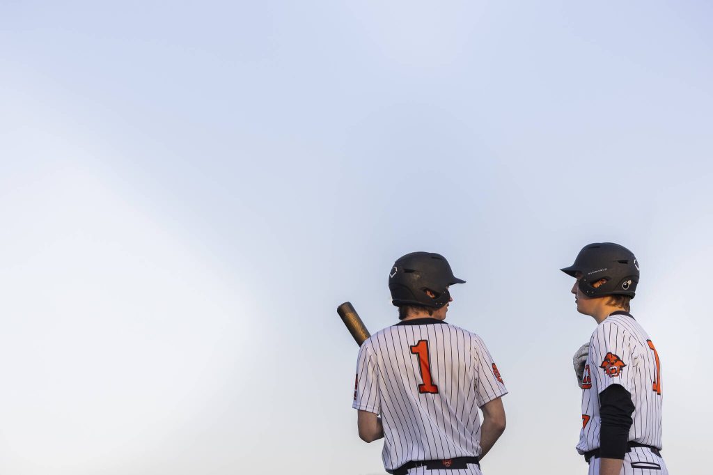 Monroes Caleb Campbell talks with teammate AJ Welch before stepping up to bat during the game against Everett on Wednesday, April 23, 2025 in Monroe, Washington. (Olivia Vanni / The Herald)