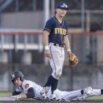 Everetts Mac Larsen spits in frustration due to a fielding error as Monroes AJ Welch slide safely into second base during the game on Wednesday, April 23, 2025 in Monroe, Washington. (Olivia Vanni / The Herald)