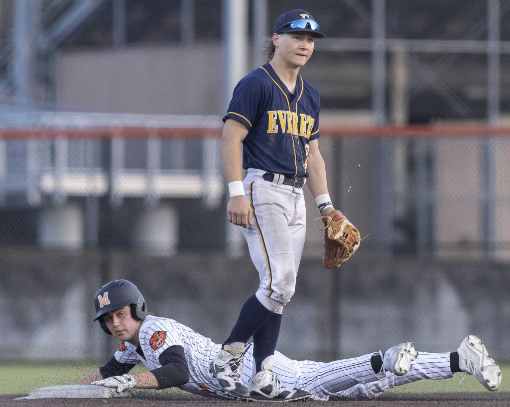 Everetts Mac Larsen spits in frustration due to a fielding error as Monroes AJ Welch slide safely into second base during the game on Wednesday, April 23, 2025 in Monroe, Washington. (Olivia Vanni / The Herald)