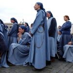 (NYT1) VATICAN CITY, April 19, 2005 -- VATICAN-CONCLAVE-1 -- Sisters with the order Lamb of God look in the direction of the chimney over the Sistine Chapel waiting for the telltale smoke to indicate the Cardinals voting on a new pope, Tuesday, April 19, 2005 in St. Peter's Square in Vatican City. (James Hill/The New York Times) *MAGS OUT/NO SALES*