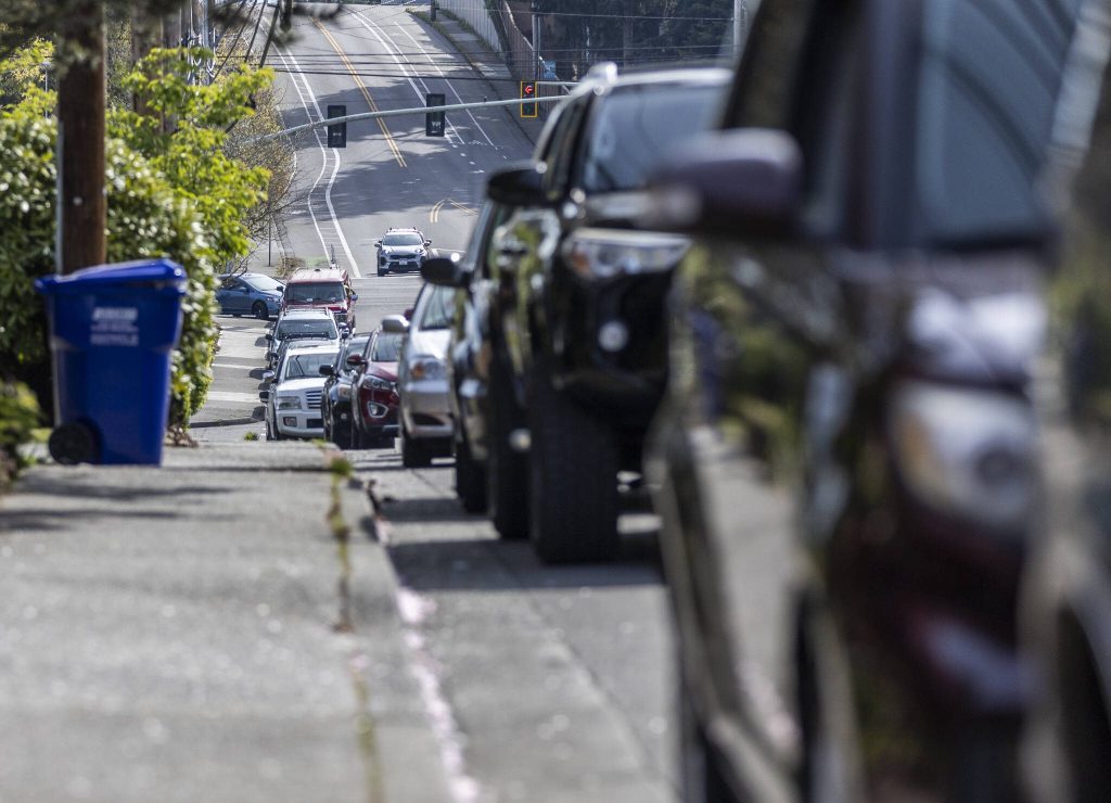 The line for the Faith Lutheran Food Bank wraps around the corner of Madison Street onto Evergreen Way on Friday, April 25, 2025, in Everett, Washington. (Olivia Vanni / The Herald)