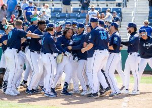 Michael Arroyo of the Everett AquaSox is surrounded by teammates after his walk-off home run against Vancouver at Funko Filed on Thursday, April 24, 2025. (Photo courtesy of Shari Sommerfeld, Everett AquaSox)