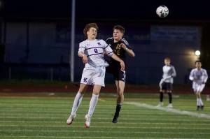 Kamiak senior Yegor Tarasov (left) jumps to head the ball Lake Stevens senior Shad Schmitt tries to defend him during Kamiak's 2-1 win in Lake Stevens, Washington on April 29, 2025. (Joe Pohoryles / The Herald)