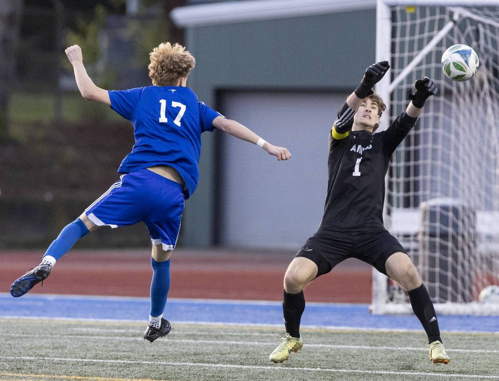 Archbishop Murphys Cameron Ilgenfritz knocks the ball away after Shorewoods Julian Shook tries to head the ball during the game on Wednesday, April 30, 2025 in Shoreline, Washington. (Olivia Vanni / The Herald)