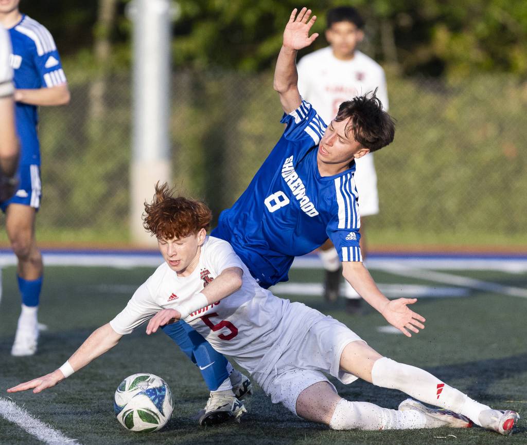 Archbishop Murphys Henry Fahey and Shorewoods Thomas Leitner both fall to the ground while going after the ball during the game on Wednesday, April 30, 2025 in Shoreline, Washington. (Olivia Vanni / The Herald)