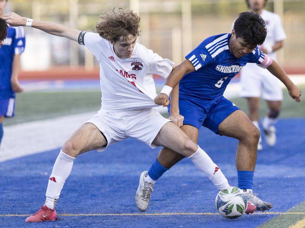 Shorewoods Isak Medhaug grabs the jersey of Archbishop Murphys Zach Mohr during the game on Wednesday, April 30, 2025 in Shoreline, Washington. (Olivia Vanni / The Herald)