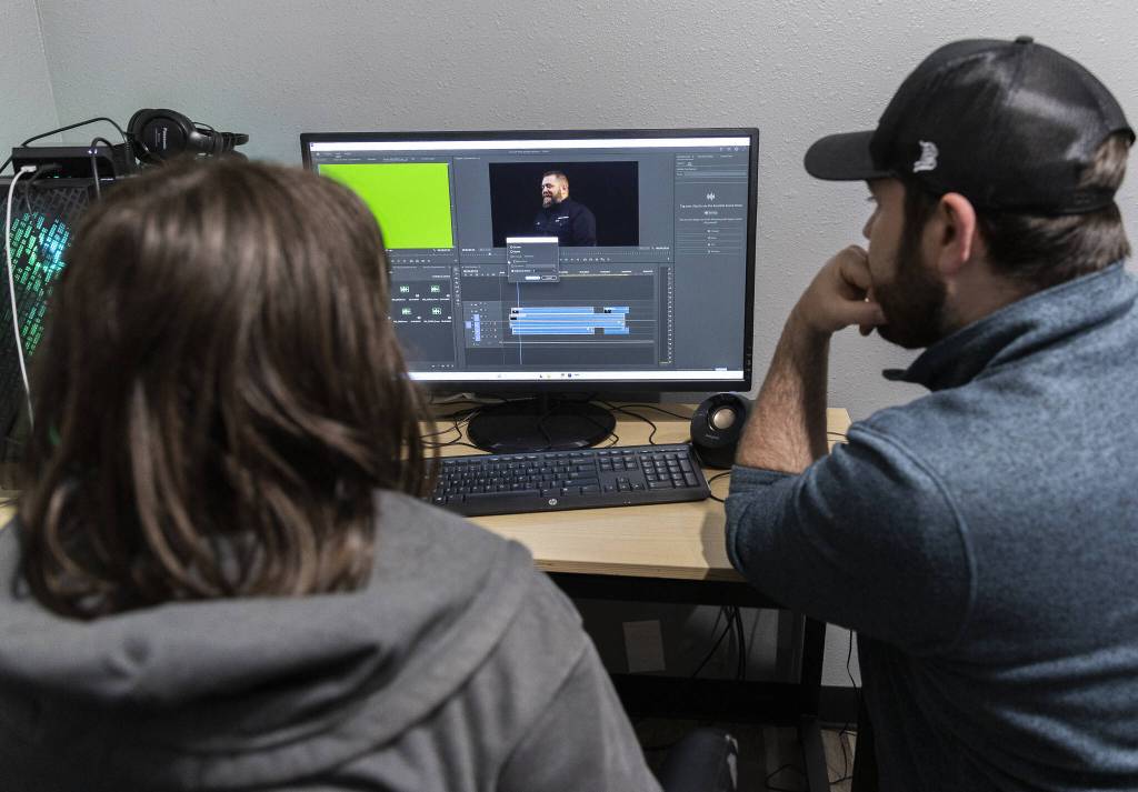 Emmalee Brazier watches as Chris Gove shows how to drag audio to start syncing at The Teen Storytellers Project on Tuesday, April 29, 2025 in Everett, Washington. (Olivia Vanni / The Herald)