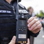 Everett Master Police Officer Travis Katzer shows one of the new police radios at a press conference outside of the new Snohomish County 911 building on Wednesday, April 30, 2025 in Everett, Washington. (Olivia Vanni / The Herald)