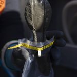 Chad Eshelman drops mixed sediment into a small bag to send off for testing on Thursday, May 1, 2025 in Everett, Washington. (Olivia Vanni / The Herald)