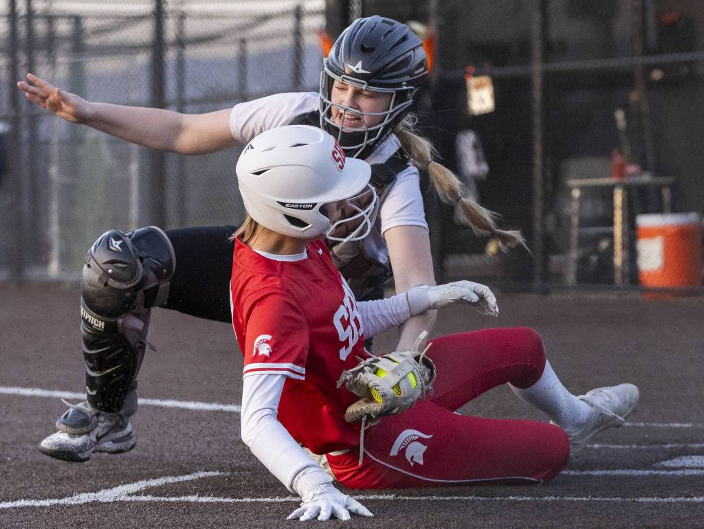 Monroes Scarlett Nagy tags out Stanwoods Olivia Dahl as she tries to slide into home plate on Thursday, May 1, 2025 in Monroe, Washington. (Olivia Vanni / The Herald)