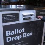 A person turns in their ballot at a ballot box located near the Edmonds Library in Edmonds, Washington on Sunday, Nov. 5, 2023. (Annie Barker / The Herald)