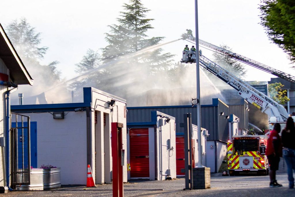 Firefighters spray water from onto Trojan Storage on Monday, May 5, 2025, in Everett, Washington. (Aaron Kennedy / The Herald)