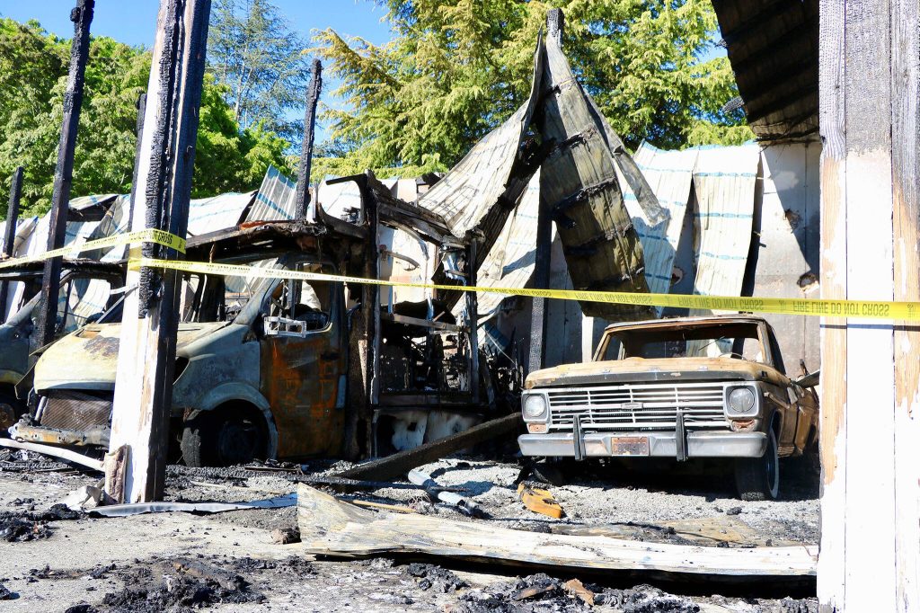 A scorched Ford pickup sits beneath a partially collapsed and blown-out roof after a fire tore through part of a storage facility Monday evening, on Tuesday, May 6, 2025, in Everett. (Aspen Anderson / The Herald)