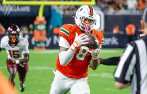 Miami Hurricanes tight end Elijah Arroyo (8) on a long pass reception against the Virginia Tech Hokies during the first half of an ACC conference football game at Hard Rock Stadium on Friday, September 27, 2024, in Miami Gardens, Fla. (Al Diaz / Tribune New Services)