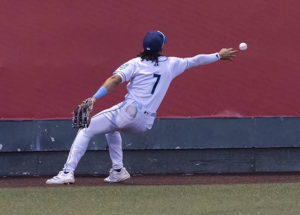 The ball flies past the outstretched hand of Everett AquaSox outfielder Tai Peete during the game against the Tri-City Dust Devils on Tuesday, May 6, 2025 in Everett, Washington. (Olivia Vanni / The Herald)