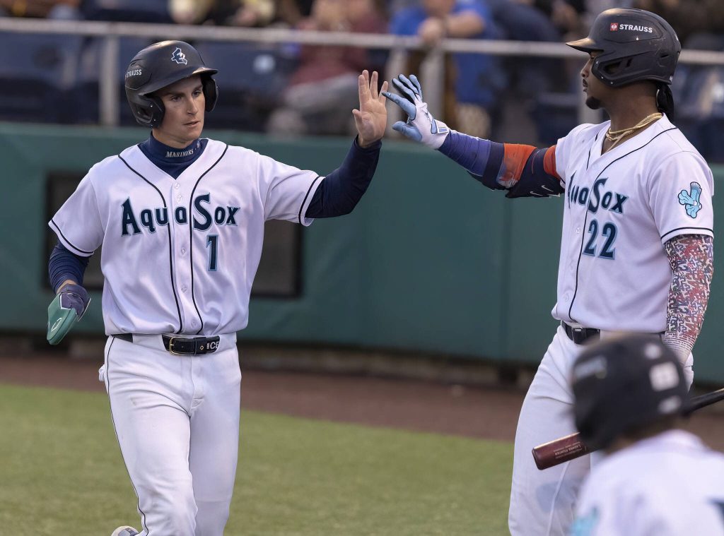 Everett AquaSox infielder Colt Emerson gets a high-five from teammate Lazaro Montes after scoring during the game against the Tri-City Dust Devils on Tuesday, May 6, 2025 in Everett, Washington. (Olivia Vanni / The Herald)
