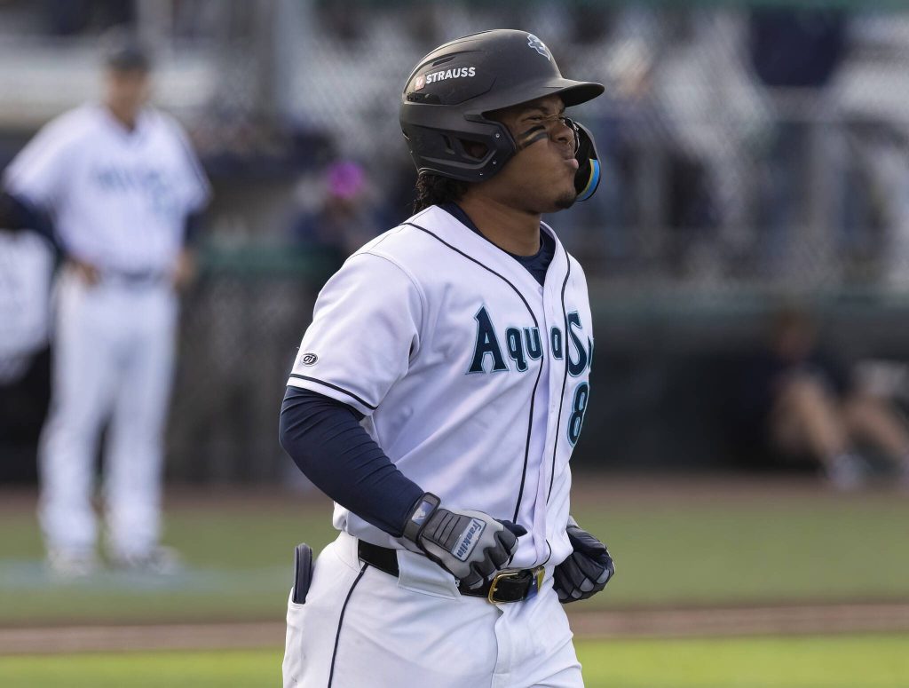 Everett AquaSox infielder Michael Arroyo grimaces as he runs to first to take his base after getting hit by a pitch during the game against Tri-City Dust Devils on Tuesday, May 6, 2025 in Everett, Washington. (Olivia Vanni / The Herald)