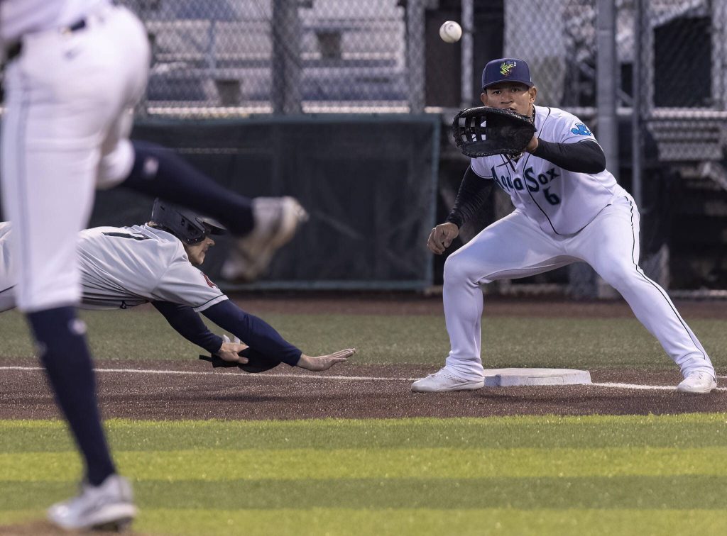 Everett AquaSox infielder Milkar Perez reaches up to catch a throw from pitcher Jordan Jackson as he tries to catch a player off first base during the game against the Tri-City Dust Devils on Tuesday, May 6, 2025 in Everett, Washington. (Olivia Vanni / The Herald)