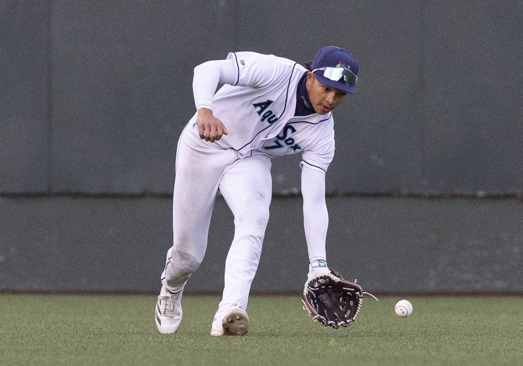 Everett AquaSox outfielder Tai Peete picks up a ball hit to the outfield during the game against the Tri-City Dust Devils on Wednesday, May 7, 2025 in Everett, Washington. (Olivia Vanni / The Herald)