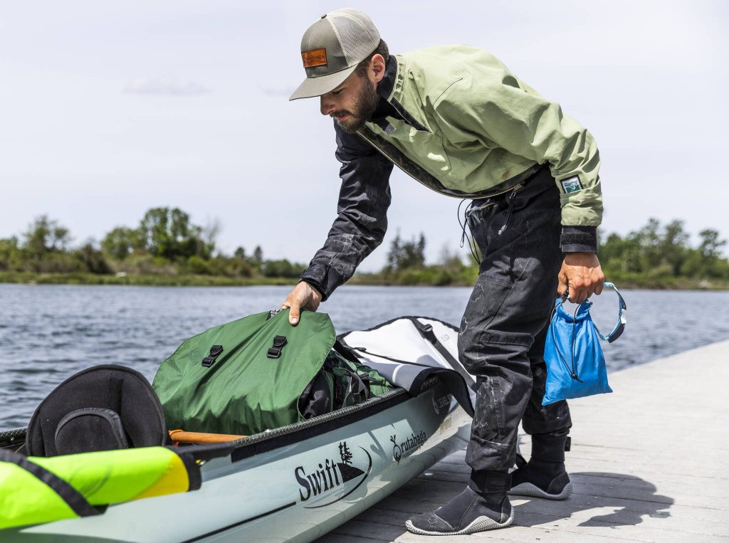 Kyle Parker shows some of the items he has packed into his canoe for his cross county trip on Thursday, May 8, 2025 in Everett, Washington. (Olivia Vanni / The Herald)