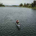 Kyle Parker paddles his canoe along the Snohomish River next to Langus Riverfront Park on Thursday, May 8, 2025 in Everett, Washington. (Olivia Vanni / The Herald)