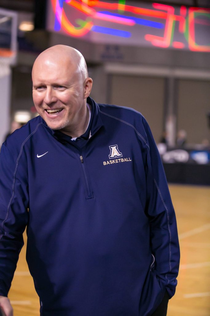 Arlington girls head basketball coach Joe Marsh greets a person during the 2020 state basketball tournament at the Tacoma Dome. (Photo courtesy of Sean Marsh)