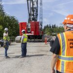 Edgewater Bridge construction workers talk as demolition continues on the bridge on Friday, May 9, 2025 in Everett, Washington. (Olivia Vanni / The Herald)