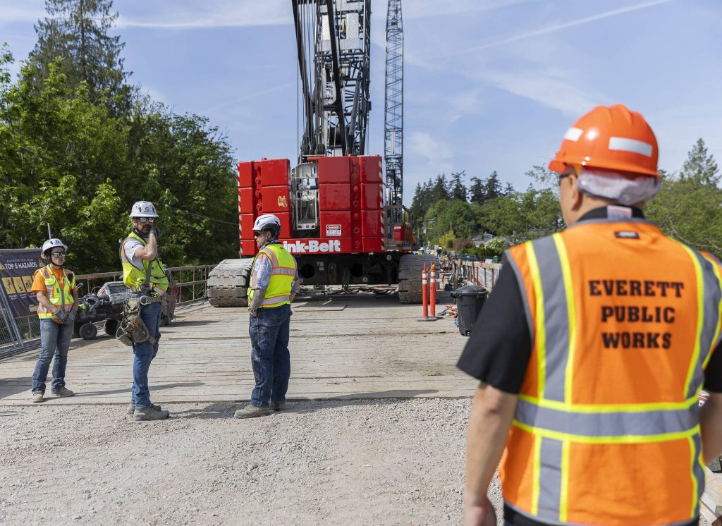 Edgewater Bridge construction workers talk as demolition continues on the bridge on Friday, May 9, 2025 in Everett, Washington. (Olivia Vanni / The Herald)