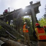 Tom Hood looks across the ravine from below the Everett side of the Edgewater Bridge on Friday, May 9, 2025 in Everett, Washington. (Olivia Vanni / The Herald)