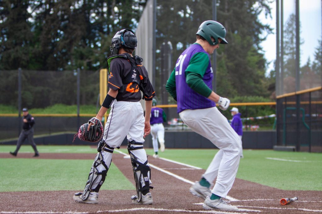 Edmonds-Woodways Alexander Archie scores the tying run in the third inning against Monroe during a district playoff game on May 10, 2025 at Edmonds-Woodway High School. (Qasim Ali / The Herald)
