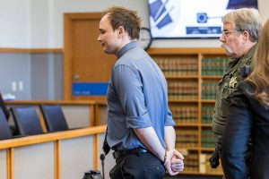Christian Sayre walks out of the courtroom in handcuffs after being found guilty on two counts of indecent liberties at the end of his trial at the Snohomish County Courthouse on Monday, May 12, 2025 in Everett, Washington. (Olivia Vanni / The Herald)