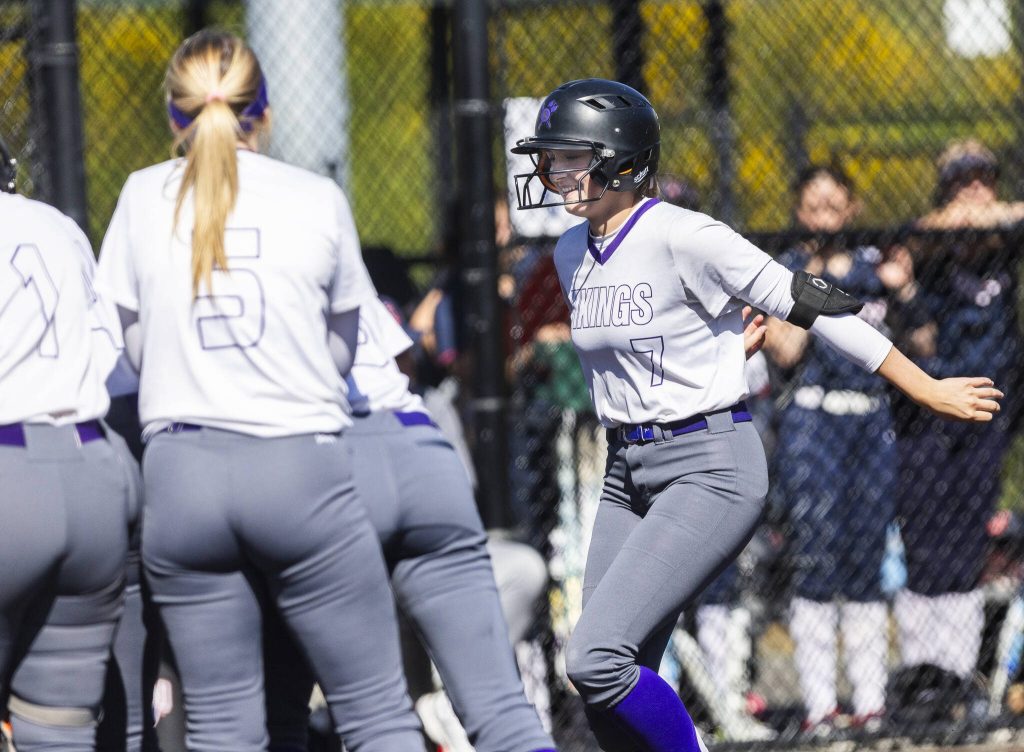 Lake Stevens McKenna Richer runs to her teammates surrounding home plate after hitting a home run during the game against Juanita on Monday, May 12, 2025 in Everett, Washington. (Olivia Vanni / The Herald)