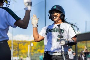 Jackson’s Elena Eigner high fives her teammate after scoring during the game on Monday, May 12, 2025 in Everett, Washington. (Olivia Vanni / The Herald)
