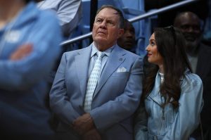 North Carolina head coach Bill Belichick and his girlfriend, Jordon Hudson, look on during the first half of a North Carolina-Duke men's basketball game at Dean E. Smith Center on March 8, 2025, in Chapel Hill, North Carolina. (Jared C. Tilton / Getty Images / Tribune News Services)