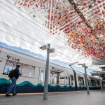 A person walks past Laura Haddad’s “Cloud” sculpture before boarding a Link car on Monday, Oct. 14, 2024 in SeaTac, Washington. (Olivia Vanni / The Herald)