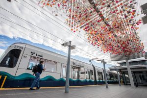 A person walks past Laura Haddad’s “Cloud” sculpture before boarding a Link car on Monday, Oct. 14, 2024 in SeaTac, Washington. (Olivia Vanni / The Herald)
