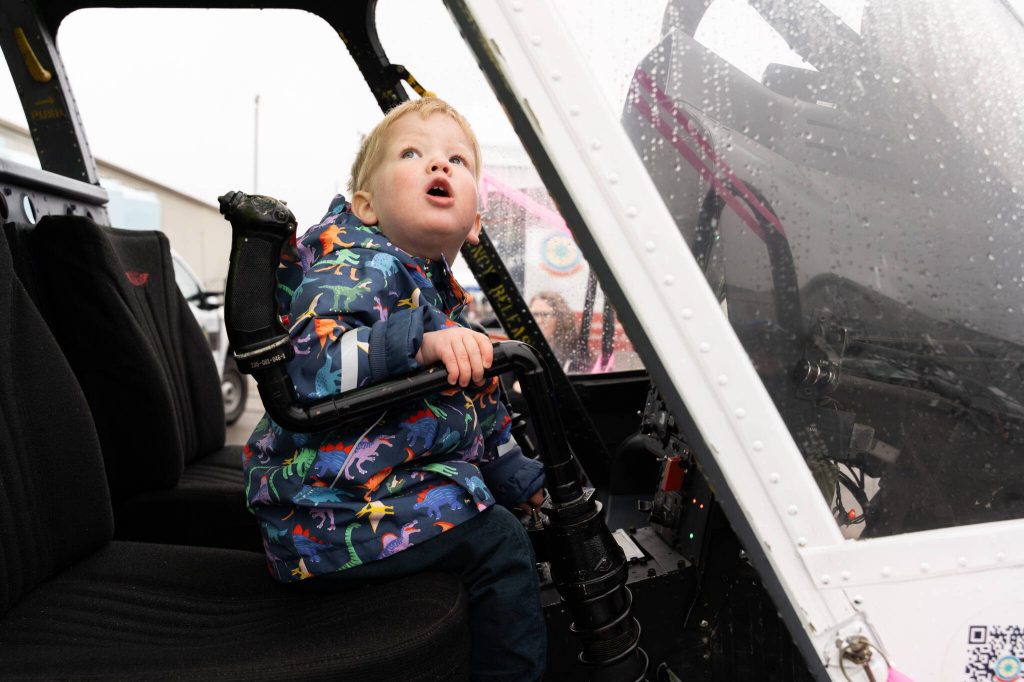 Cal Brennan, 1, sits inside a helicopter during Paine Field Community Day on Saturday in Everett. (Will Geschke / The Herald)