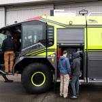 Visitors look at a new fire engine during Paine Field Community Day on Saturday in Everett. (Will Geschke / The Herald)