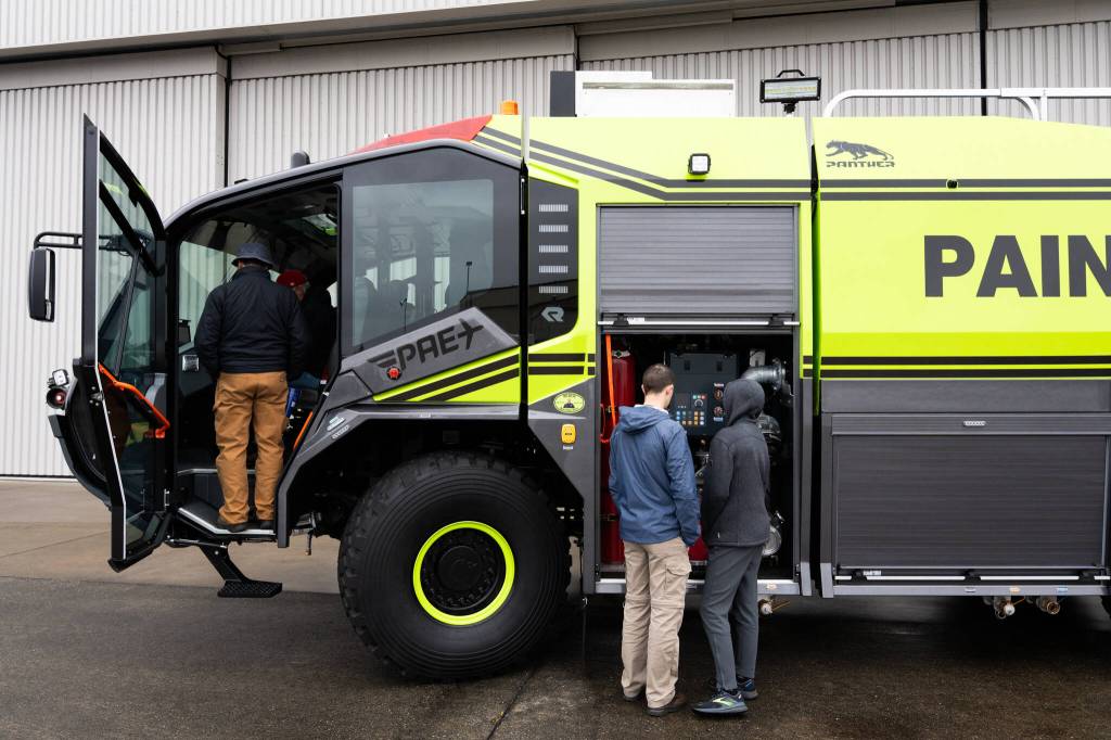 Visitors look at a new fire engine during Paine Field Community Day on Saturday in Everett. (Will Geschke / The Herald)