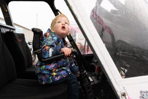 Cal Brennan, 1, sits inside of a helicopter during the Paine Field Community Day on Saturday, May 17, 2025 in Everett, Washington. (Will Geschke / The Herald)