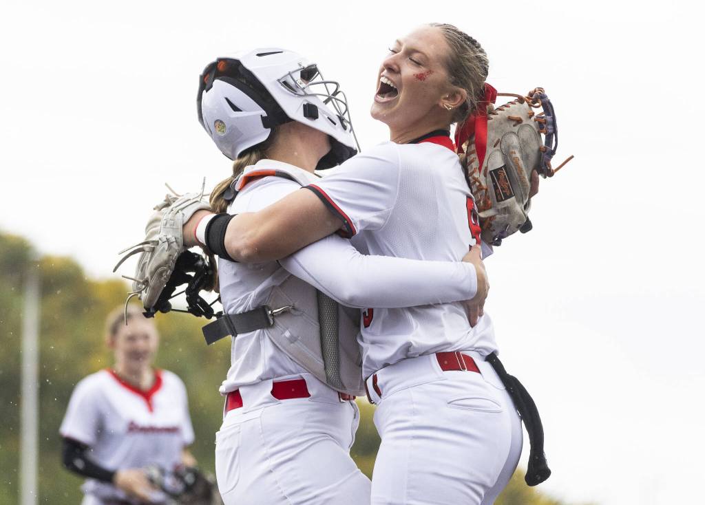 Snohomishs Abby Edwards hugs her teammate after beating Edmonds-Woodway in the 3A District 1 consolation game on Thursday, May 15, 2025 in Snohomish, Washington. (Olivia Vanni / The Herald)