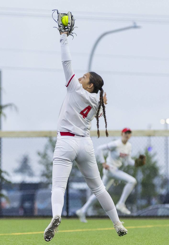 Stanwoods Taylor Almanza leaps in the air to make a catch for an out during the 3A District 1 championship game against Sedro-Woolley on Thursday, May 15, 2025 in Everett, Washington. (Olivia Vanni / The Herald)