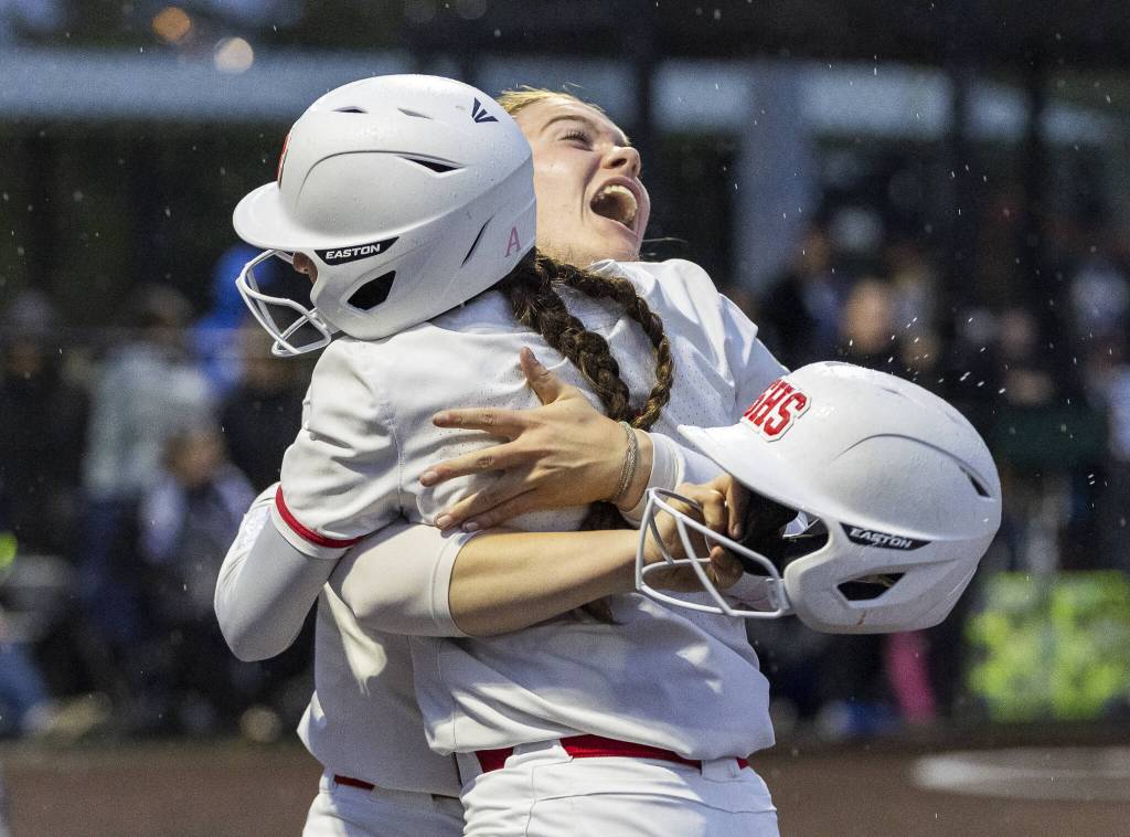 Stanwoods Addi Anderson hugs her teammate during the 3A District 1 championship game against Sedro-Woolley on Thursday, May 15, 2025 in Everett, Washington. (Olivia Vanni / The Herald)