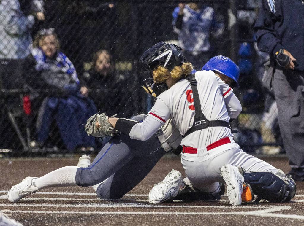 Stanwoods Addi Anderson makes an out at home plate to keep Sedro-Woolley from scoring during the 3A District 1 championship on Thursday, May 15, 2025 in Everett, Washington. (Olivia Vanni / The Herald)