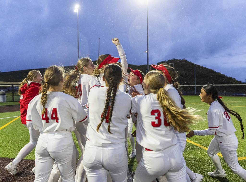 Stanwood player celebrate beating Sedro-Woolley in the 3A District 1 Championship on Thursday, May 15, 2025 in Everett, Washington. (Olivia Vanni / The Herald)