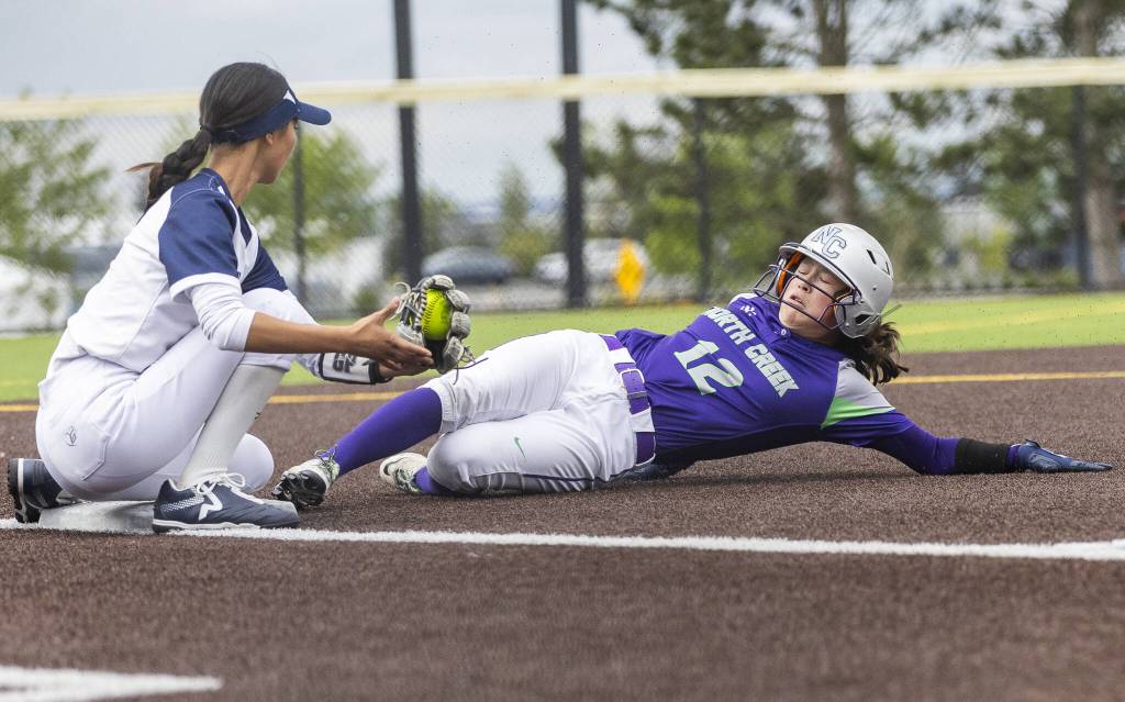 Glacier Peaks Alexis Garcia tries to tag out a North Creek player as they slide into third during the 4A District 1 consolation game against North Creek on Friday, May 16, 2025 in Everett, Washington. (Olivia Vanni / The Herald)