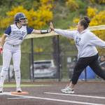 Glacier Peaks Emma Hirshorn high-fives her coach after getting a base hit during the 4A District 1 consolation game against North Creek on Friday, May 16, 2025 in Everett, Washington. (Olivia Vanni / The Herald)
