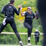 Jackson’s Matea Lopez and Allie Thomsen leap in the air and high five during the 4A District 1 game against Lake Stevens on Friday, May 16, 2025 in Everett, Washington. (Olivia Vanni / The Herald)